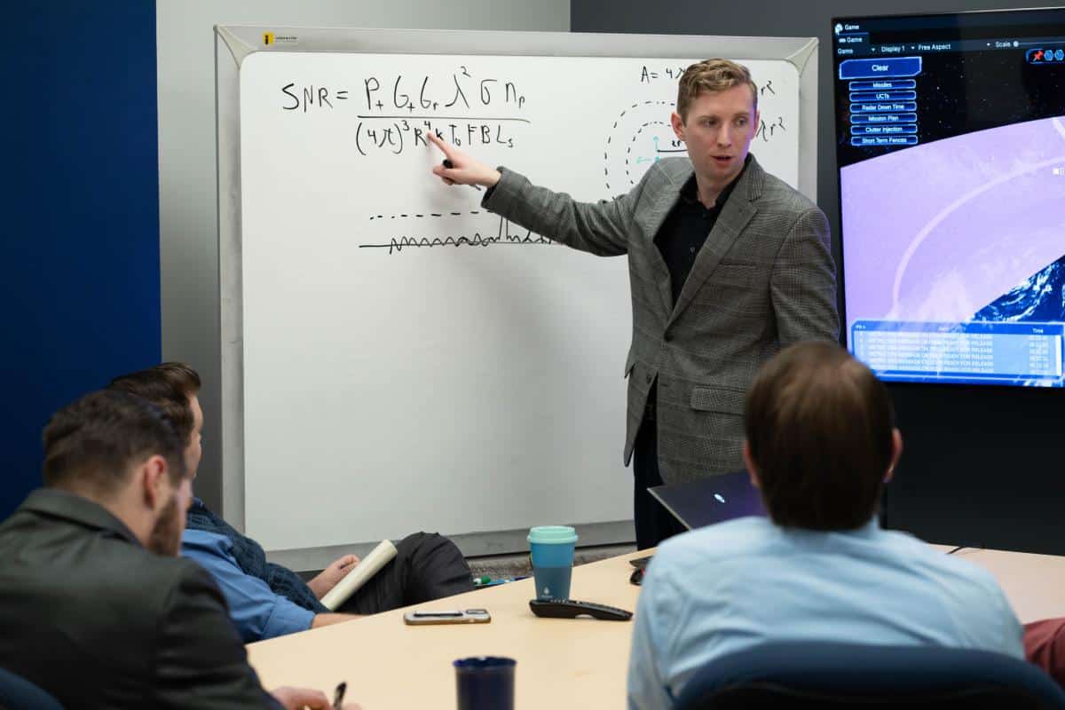Instructor at whiteboard in a classroom