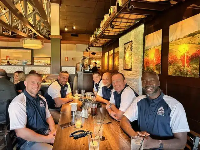 Delta Solutions & Strategies team members gathering during company event.